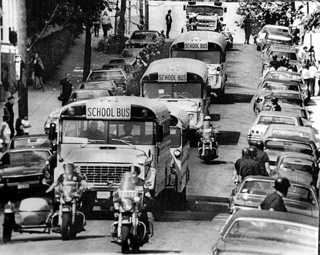 Police  protect school buses in Boston, MA, in 1974 during forced busing to racially integrate schools. Peter Bregg/AP