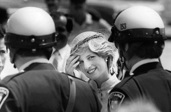 CPT107 August 31)--SAYING THANKS--Diana, Princess of Wales pushes hair from her face as she thanks her motorcycle police escort in Ottawa, prior to departing from Canada's captial in this June 22, 1983 photo. (CP PHOTO) 1983 (Stf-Peter Bregg)